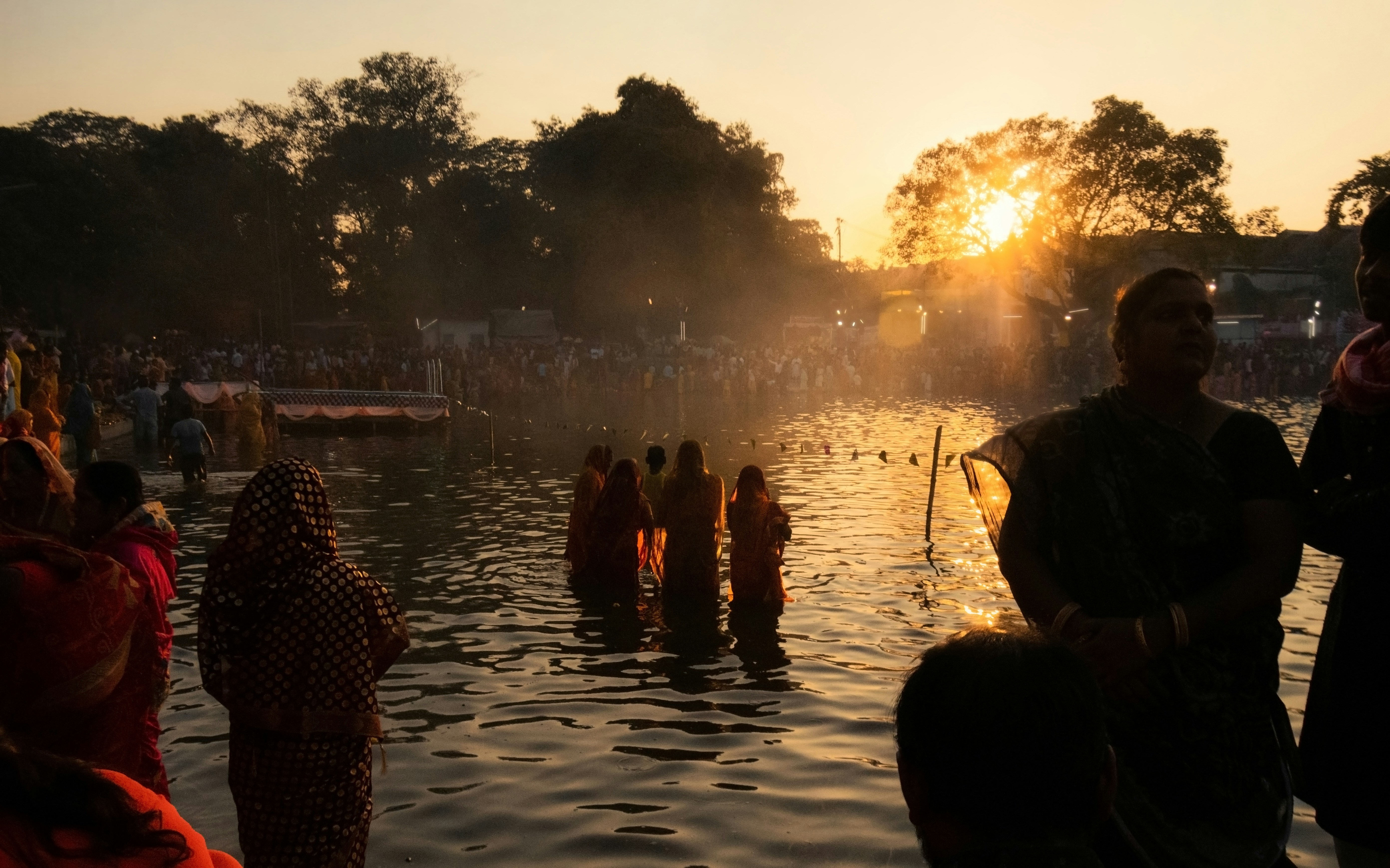 a group of people standing in a body of water