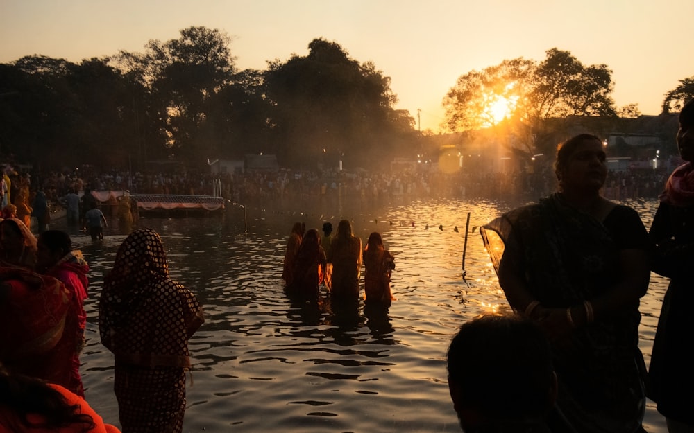 a group of people standing in a body of water