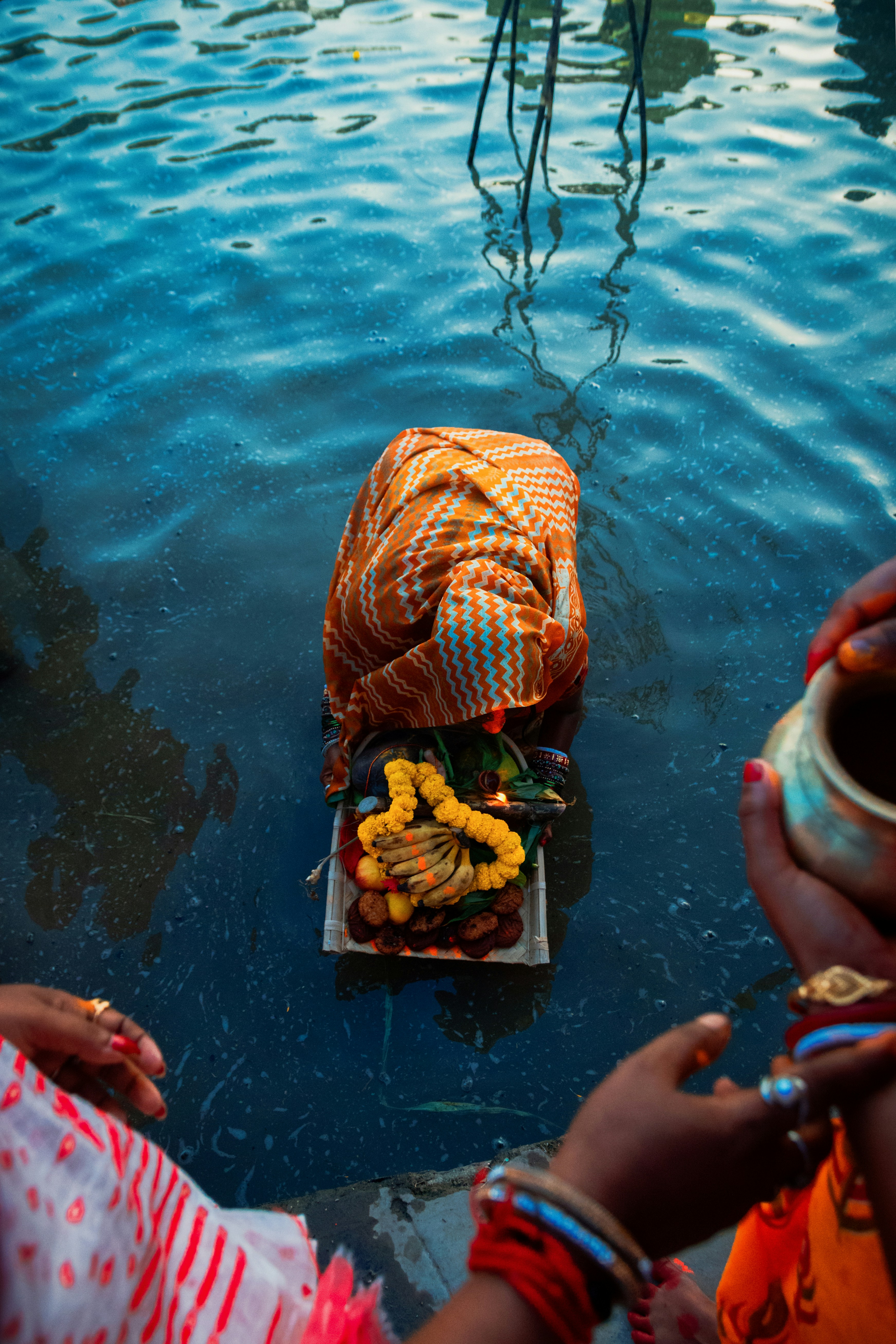 a group of people standing around a body of water