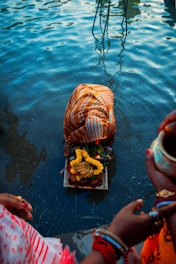 a group of people standing around a body of water