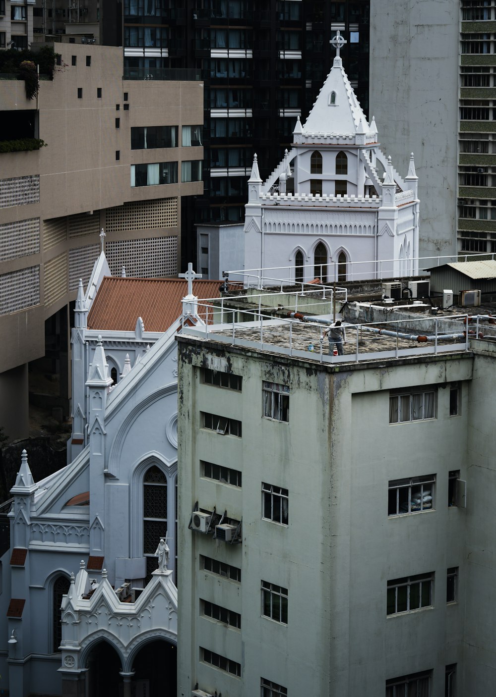 a white building with a steeple in the middle of a city