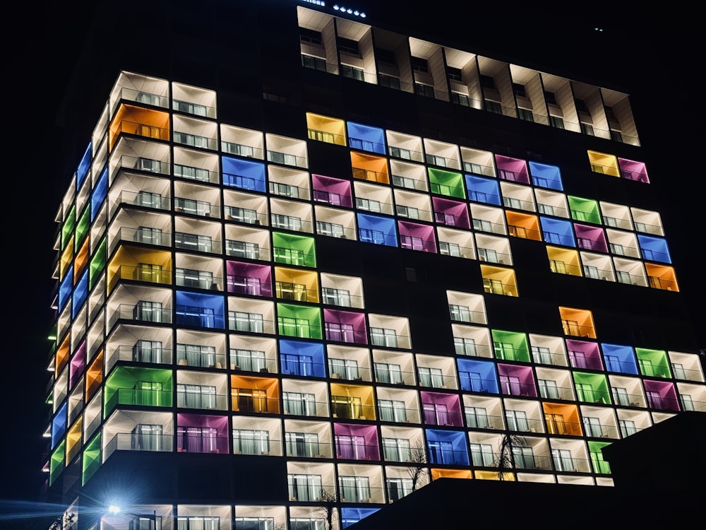 a multicolored building lit up at night