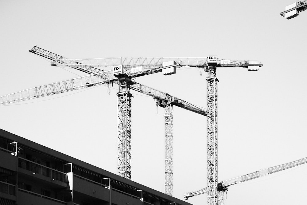 a black and white photo of a crane and a building