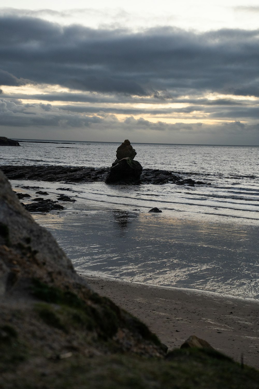 a person standing on a beach next to the ocean