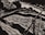 A monochromatic illustration featuring a dynamic composition with curved and sharp lines. It includes abstract forms that resemble a river or stream flowing past angular and curved structures, possibly rocks or hills, with a prominent object resembling a wooden bridge or structure.