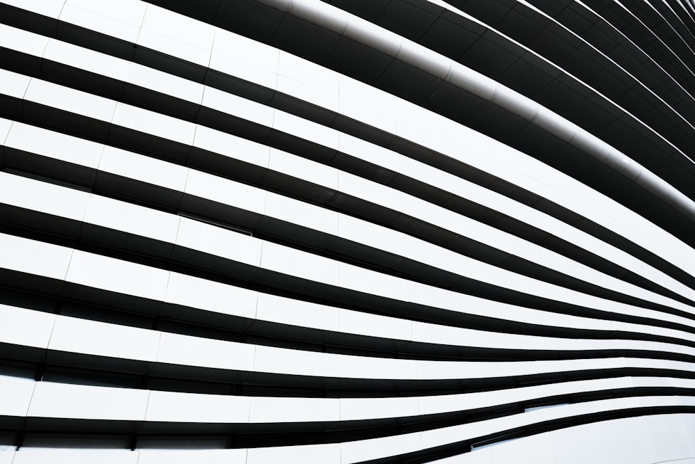 a black and white photo of a curved building