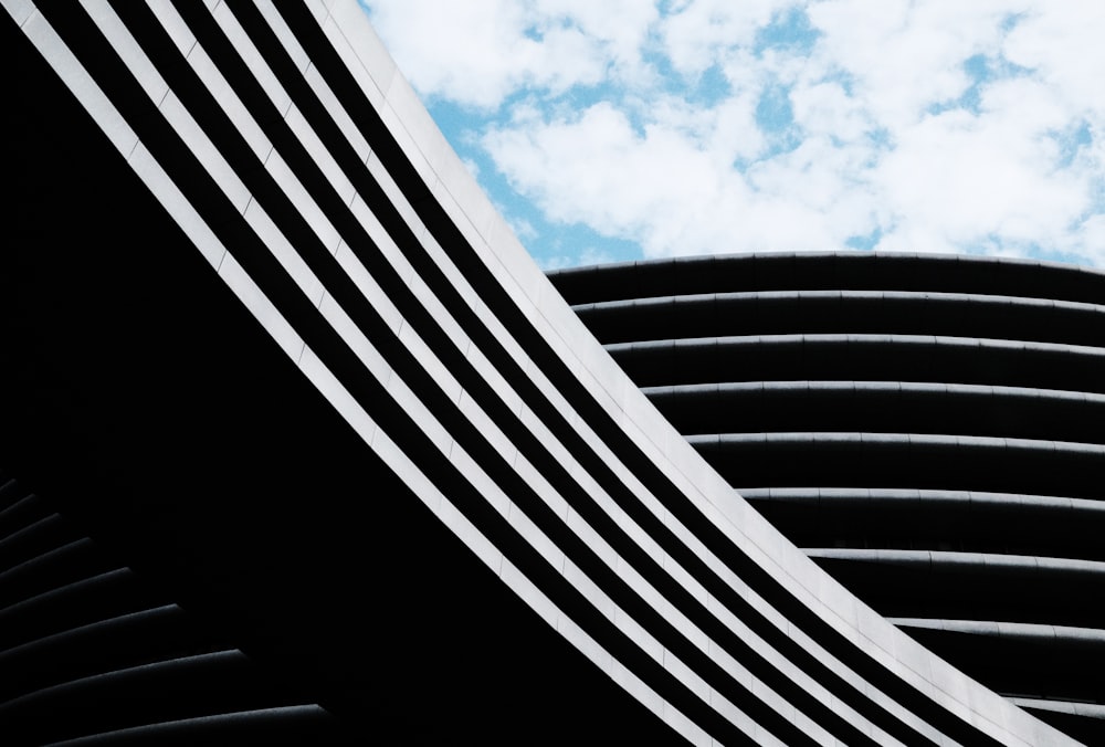 a black and white photo of a curved building