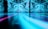 A large-scale digital art installation featuring swirling patterns of blue and cyan shades on a wall. The reflective surface in the foreground extends the patterns, creating a mesmerizing and immersive visual experience.