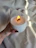 Close-up of a hand-poured candle glowing softly with a wooden wick flickering gently.