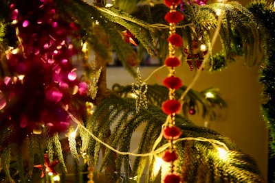 Close-up of elegant Christmas card decorations hanging on a mantelpiece, showcasing intricate designs and vibrant colors.