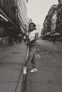 Minimalist black and white photo of a person wearing Zero Shot apparel in an urban setting.