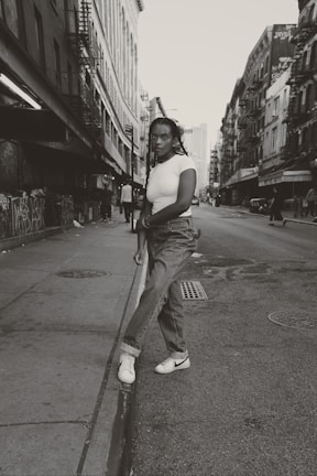 Black and white photo of a person wearing Kryol streetwear on a city street.