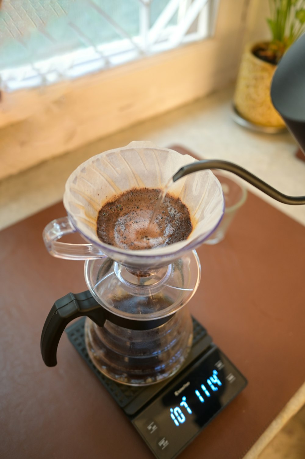 a coffee pot on top of a scale on a table