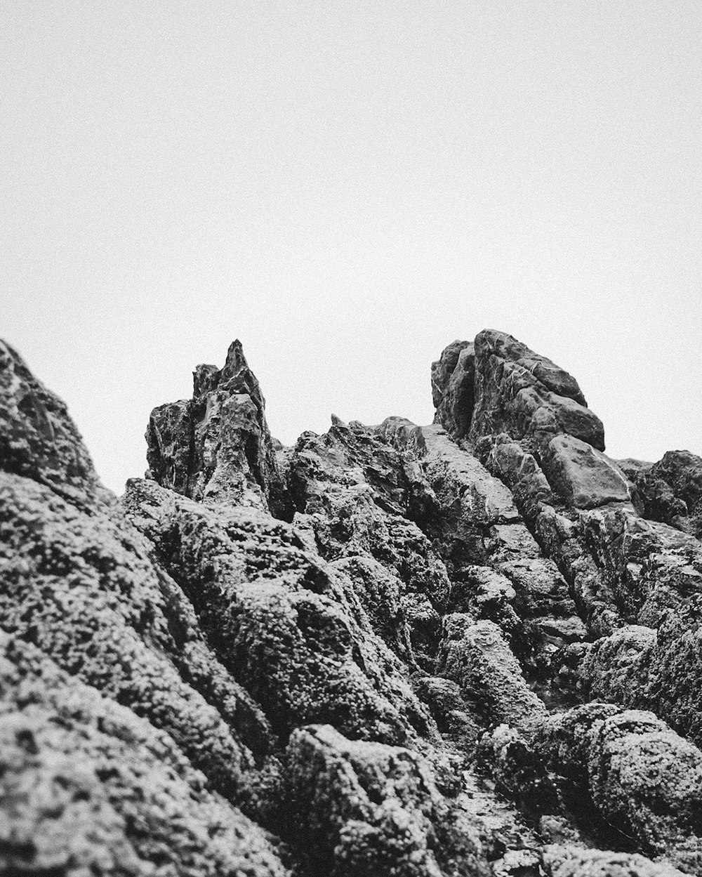 a black and white photo of a rocky mountain