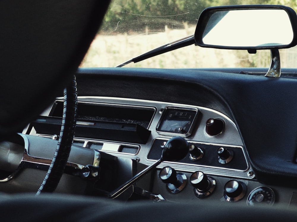 a dashboard of a car with buttons and controls