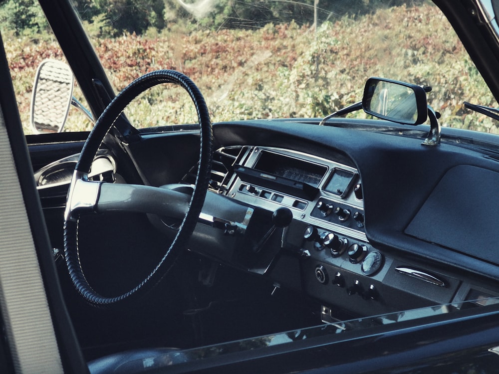 the interior of a car with a steering wheel and dashboard