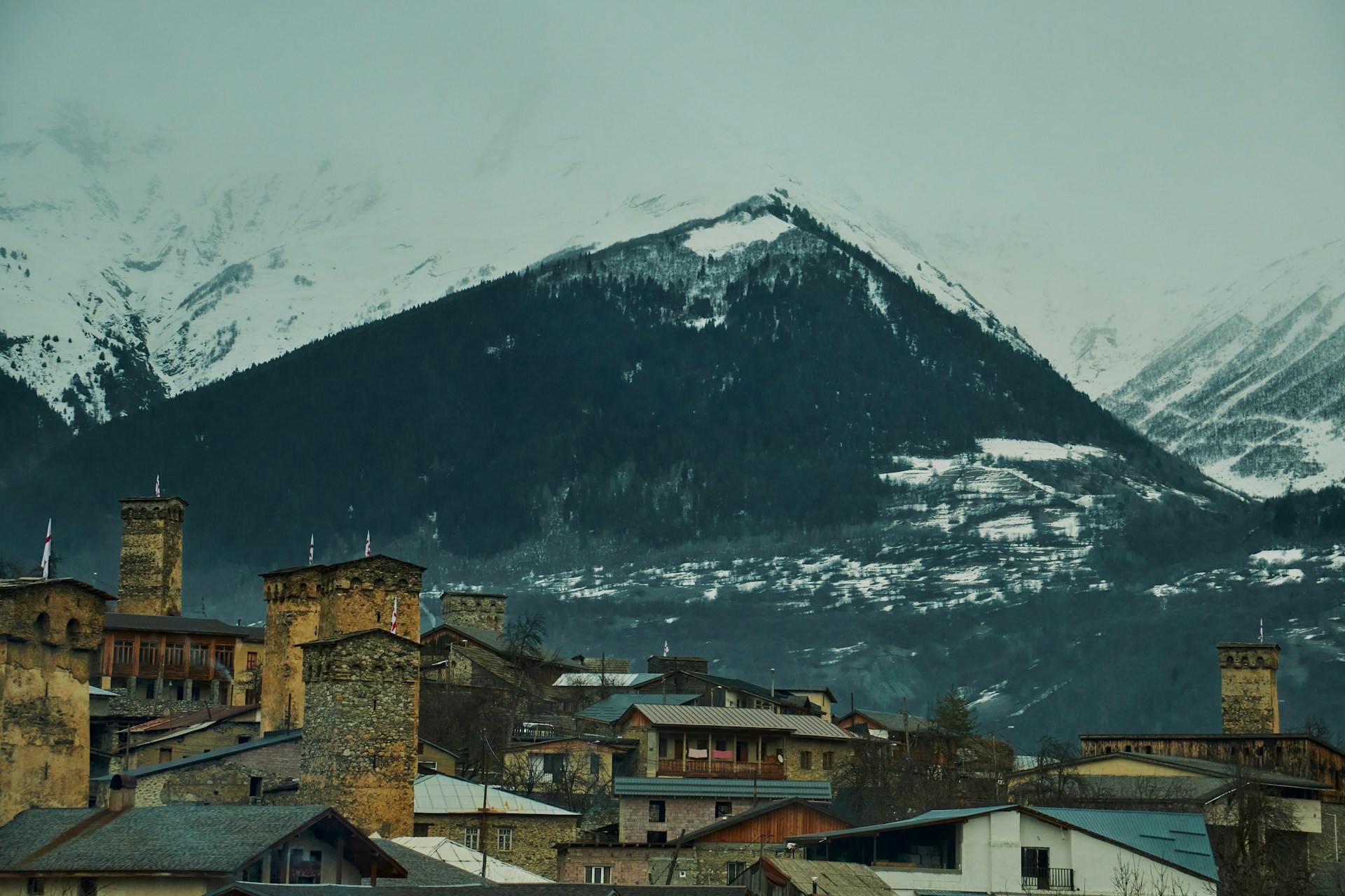 Snow-capped peaks of the Atlas Mountains with a trail winding through traditional Berber villages.