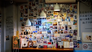 A wall filled with archived photos and notes, preserving the history of El Imperio del Mal.
