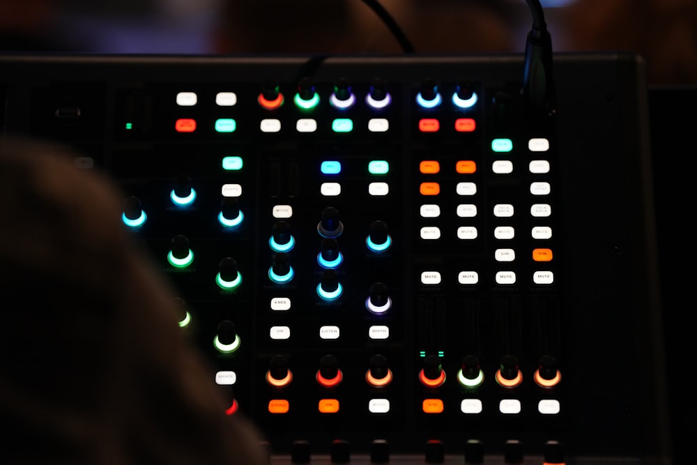 a close up of a sound board in a dark room