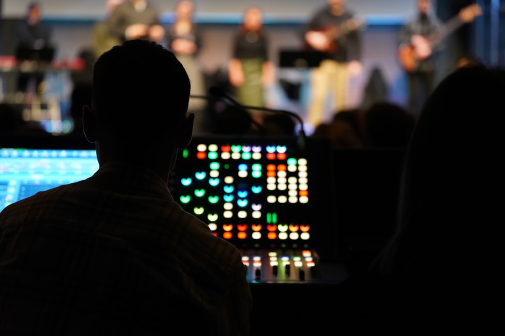 a man sitting in front of a laptop computer