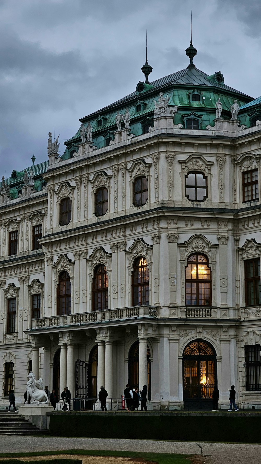 a large white building with a green roof