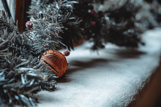 Close-up of delicate miniature ornaments arranged on a rustic wooden table.