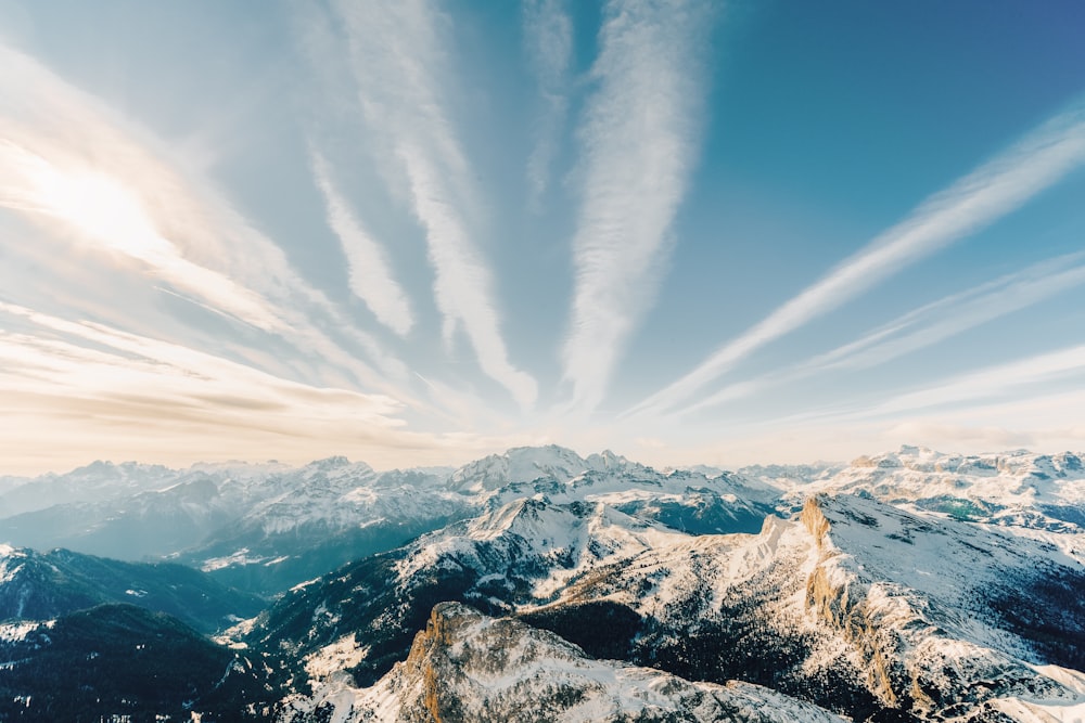 a view of a mountain range with clouds in the sky