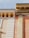 A detailed close-up of classic architectural elements featuring ornate cornices and decorative moldings. The structure showcases a blend of smooth and textured surfaces with intricate detailing around the edges.