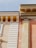A detailed close-up of classic architectural elements featuring ornate cornices and decorative moldings. The structure showcases a blend of smooth and textured surfaces with intricate detailing around the edges.