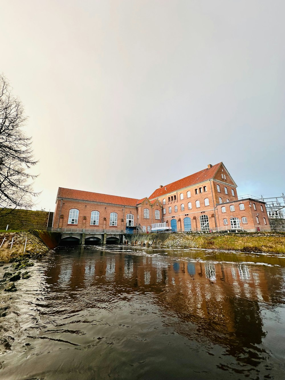 a large brick building sitting next to a river