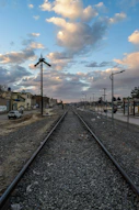 a train track with a sky in the background