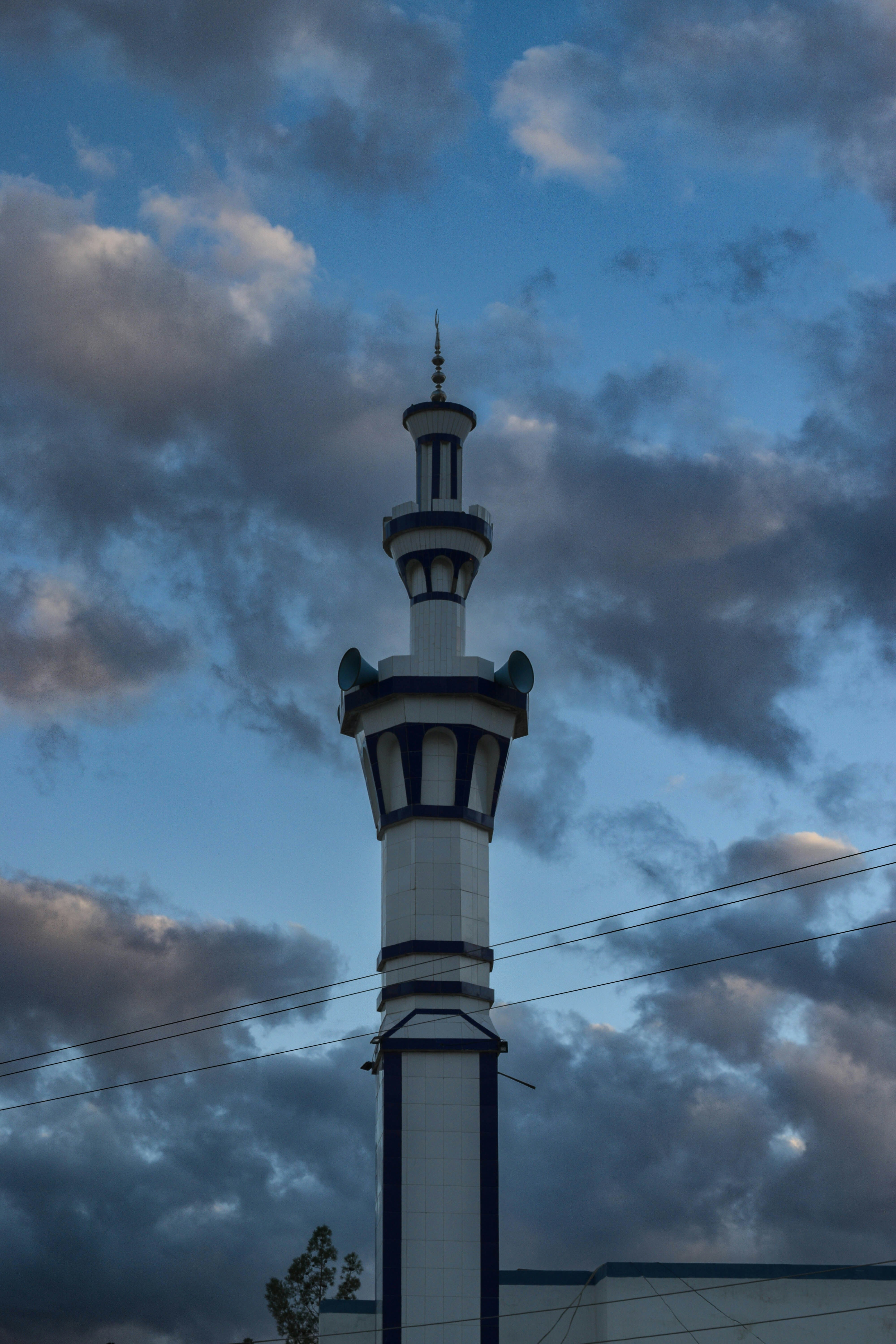 A tall tower with a clock on the top of it photo – Free Blue Image on ...