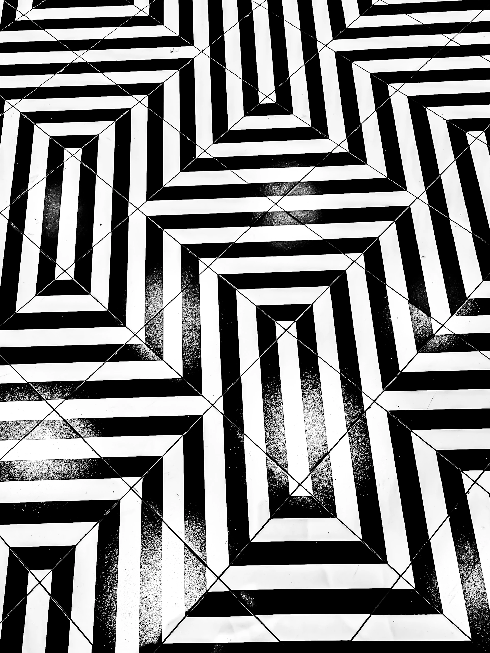 a black and white photo of a tiled floor