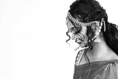 A serene portrait of a woman adorned in House of Lashkara’s delicate antique gold earrings, embodying grace and strength.