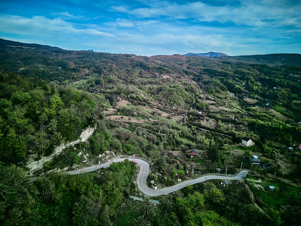 an aerial view of a winding road in the mountains