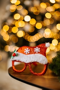 Close-up of colorful contact lenses arranged in a festive pattern with Christmas decorations.