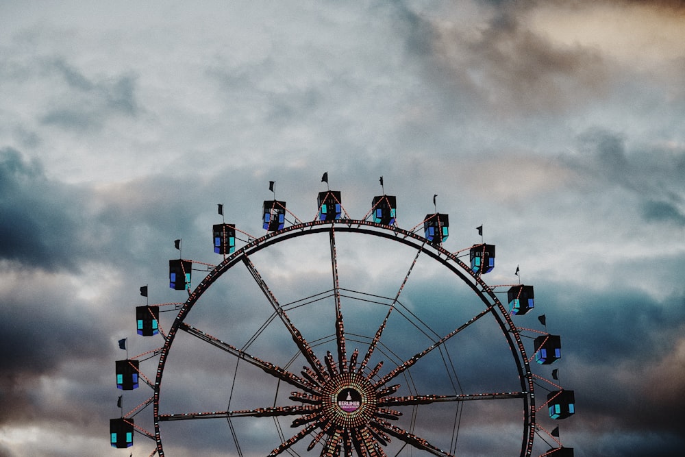 a ferris wheel in front of a cloudy sky