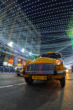 A yellow taxi navigating through the streets of Beylikdüzü at sunset.