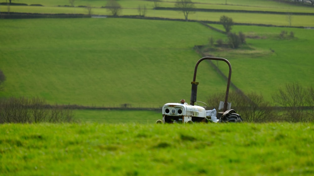 a tractor is parked in a field of green grass