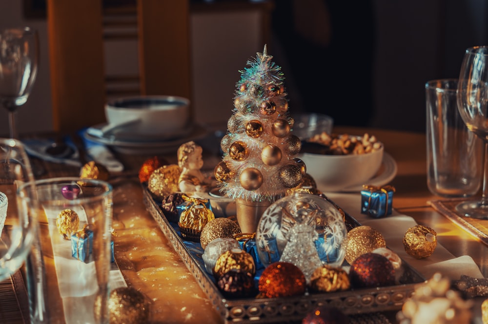 a christmas tree is sitting on a tray on a table