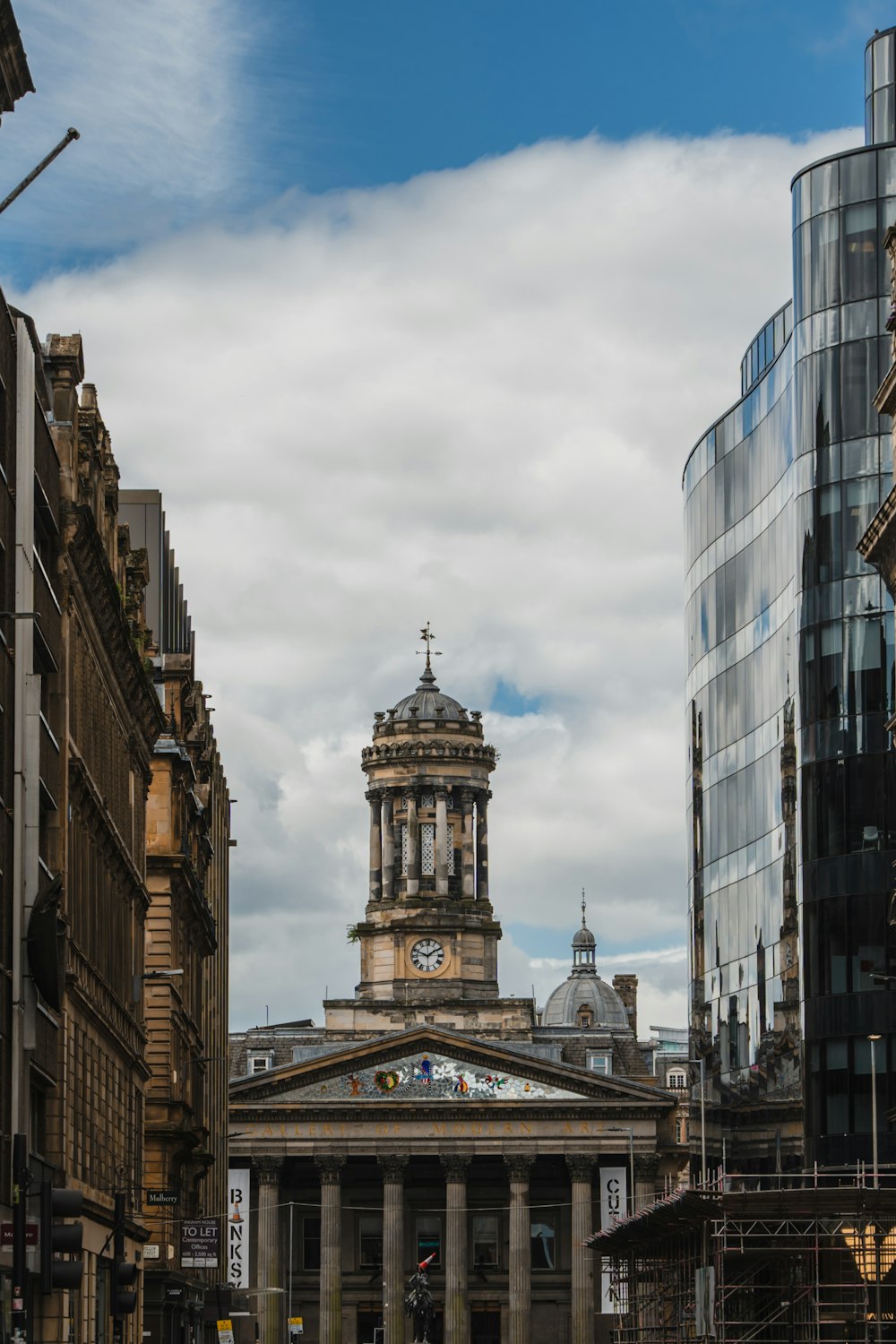 a building with a clock tower in the middle of a city