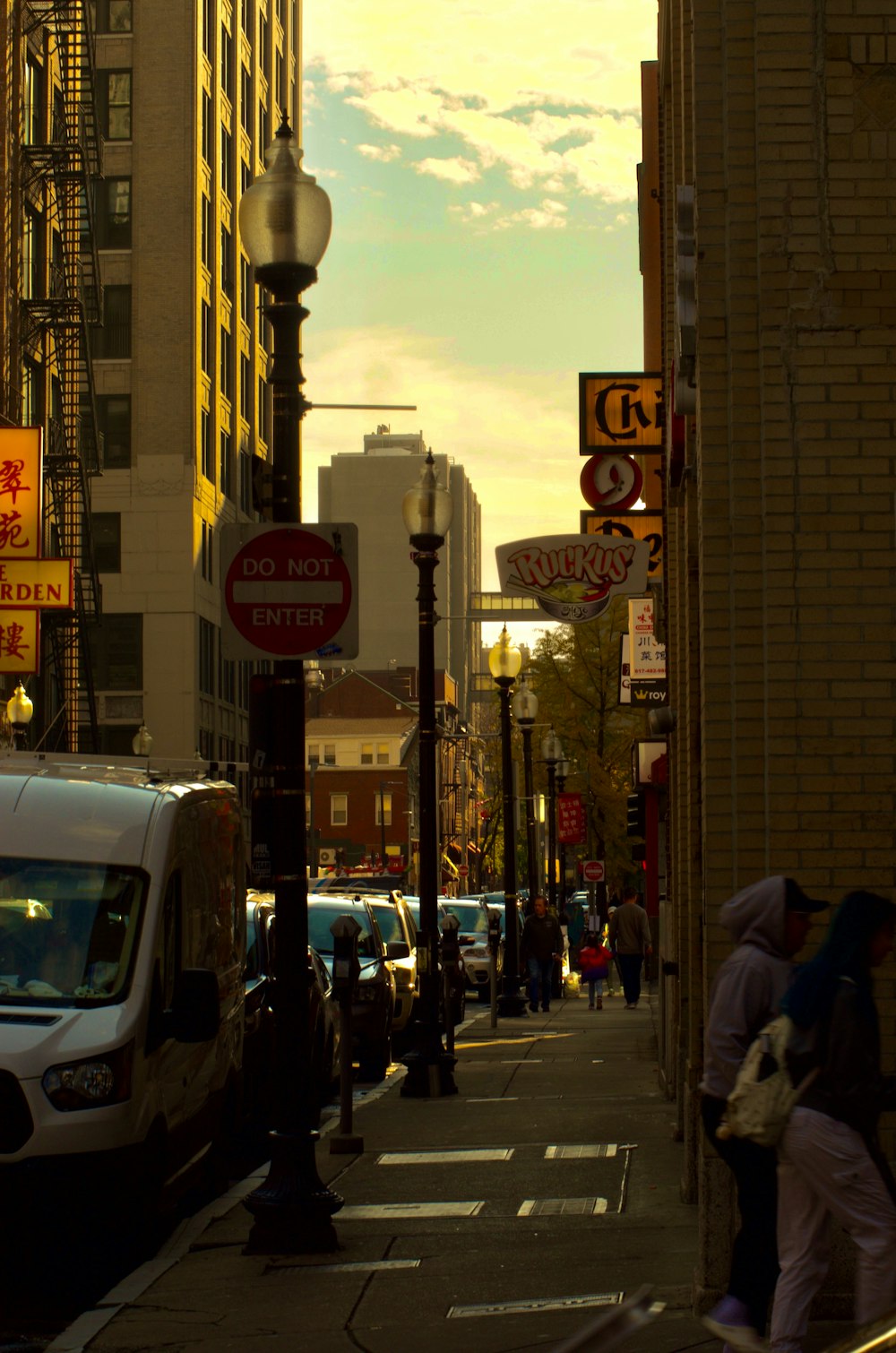 a city street filled with lots of traffic next to tall buildings