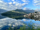 View of a peaceful lake reflecting the surrounding mountains near Geneva.