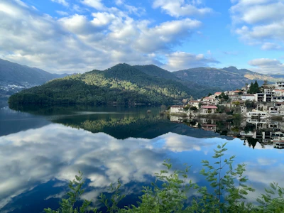 View of a peaceful lake reflecting the surrounding mountains near Geneva.