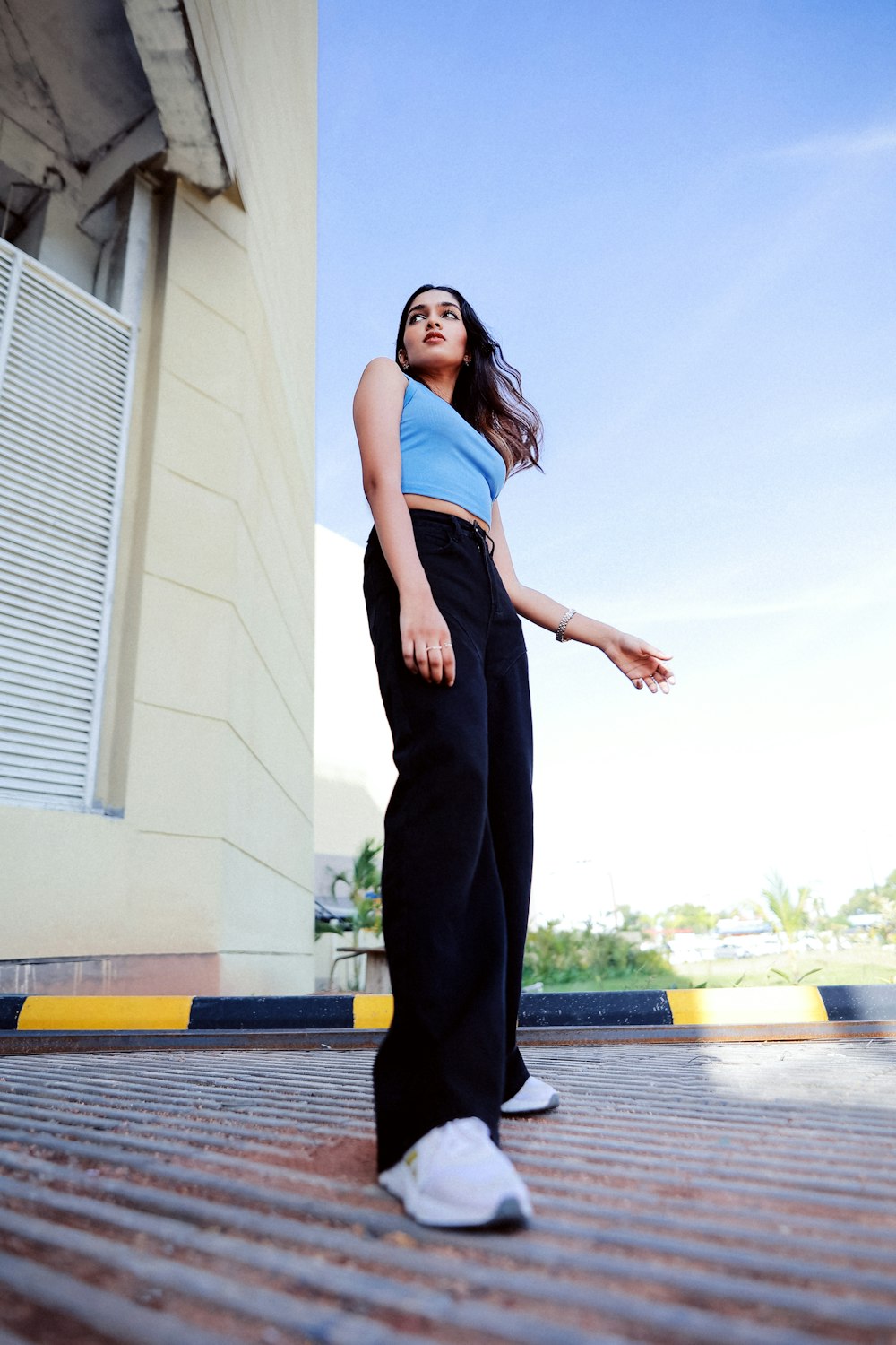 a woman in a blue top and black pants