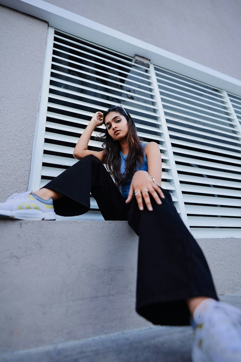 a woman sitting on a ledge next to a window