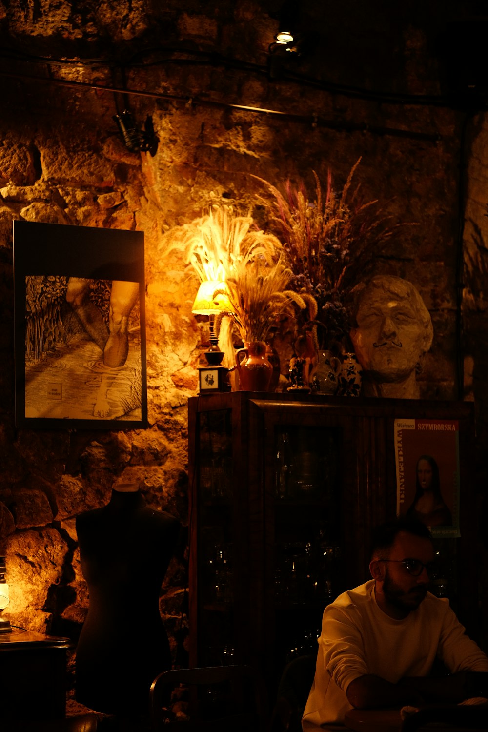 a man sitting at a table in a dimly lit room