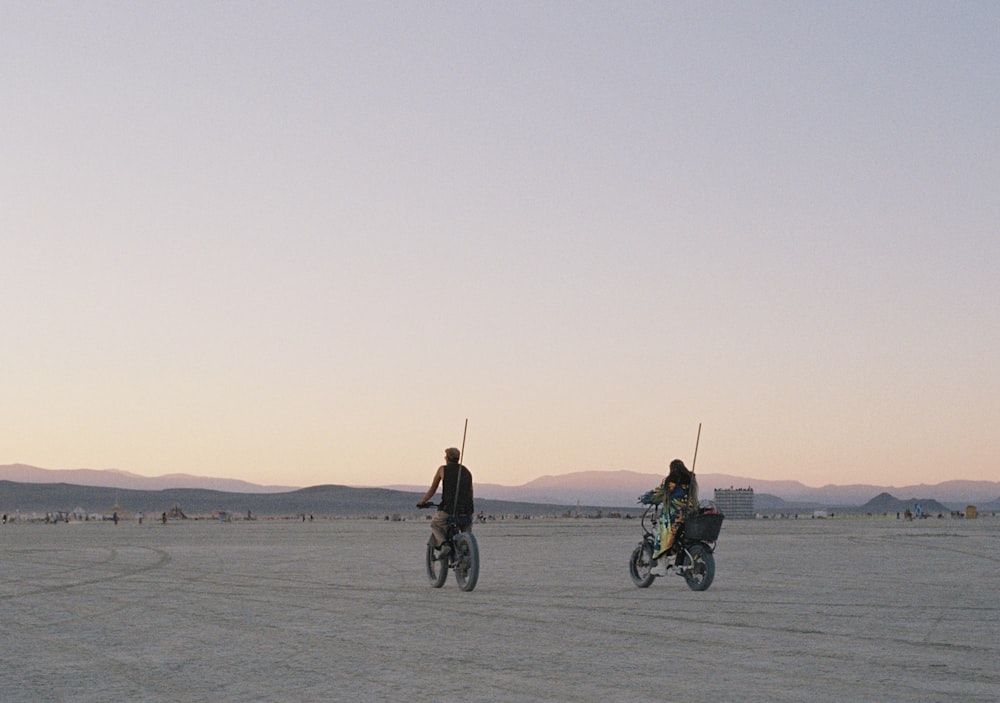 a couple of people riding on the back of bikes