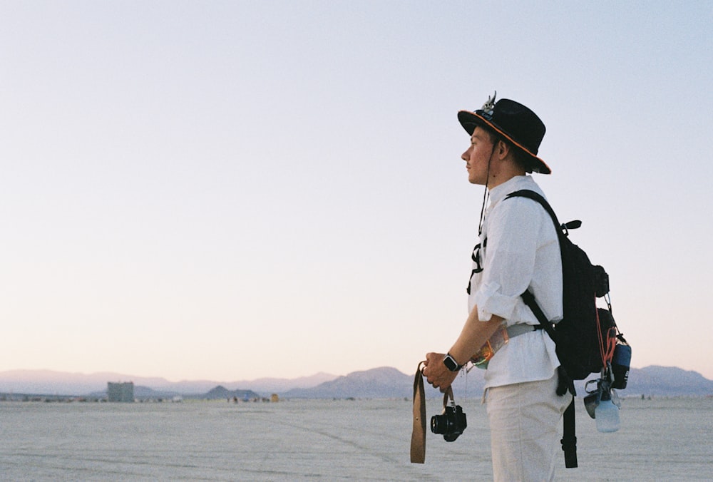 a man with a camera and a backpack