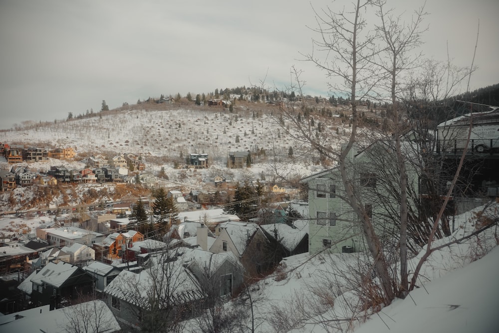 a view of a town in the mountains covered in snow